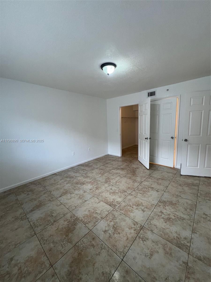 15422 Southwest 284th Street, Unit 7104 Homestead, FL 33033 - Photo 18 of 31 an empty room with a natural light