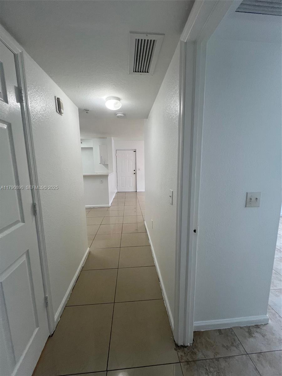 15422 Southwest 284th Street, Unit 7104 Homestead, FL 33033 - Photo 21 of 31 a view of hallway with cabinets