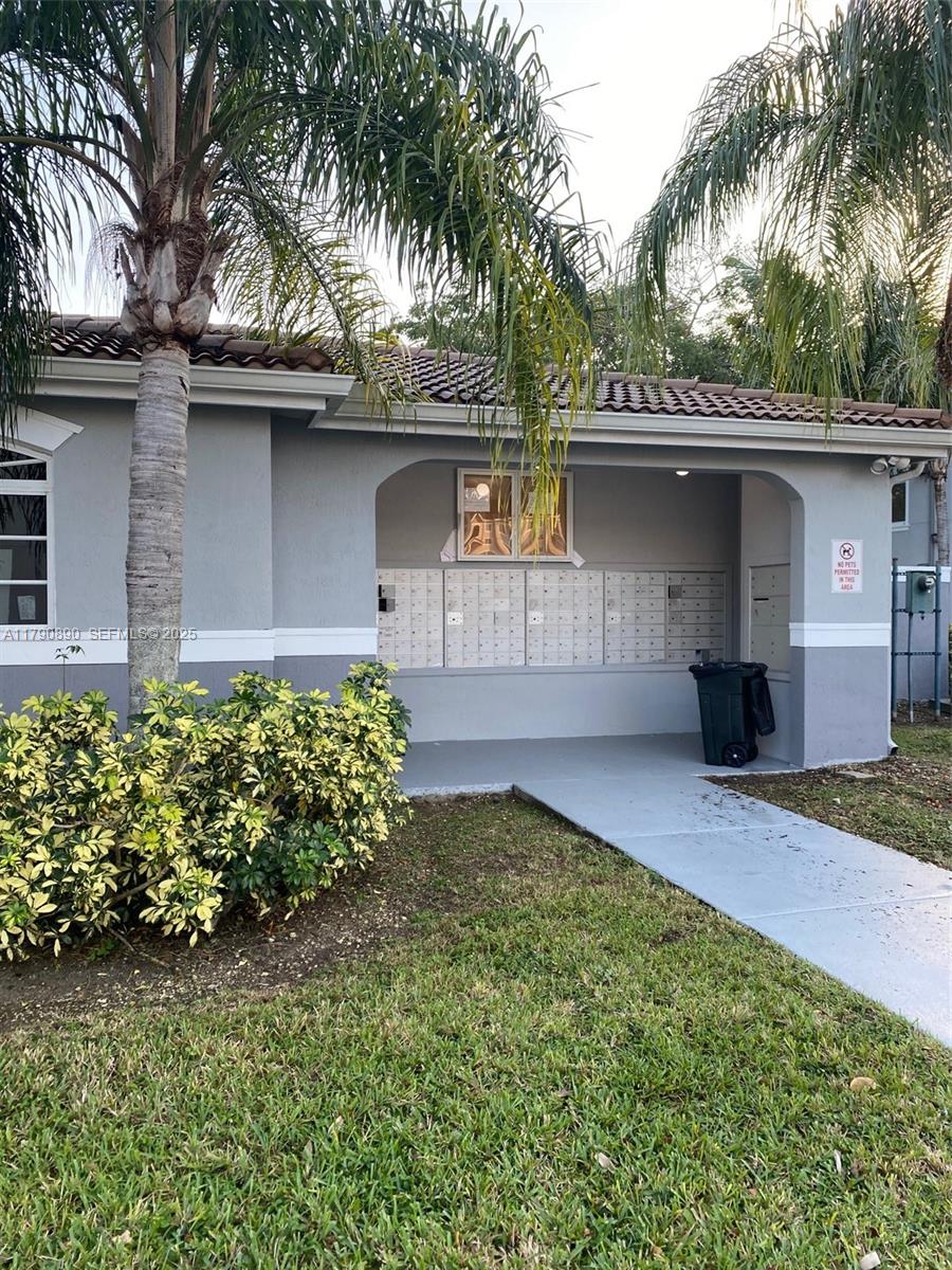 15422 Southwest 284th Street, Unit 7104 Homestead, FL 33033 - Photo 25 of 31 a front view of a house with a garden