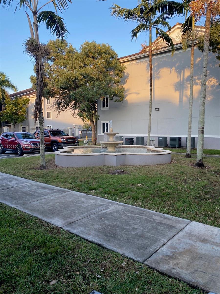 15422 Southwest 284th Street, Unit 7104 Homestead, FL 33033 - Photo 30 of 31 a couple of cars parked in front of house