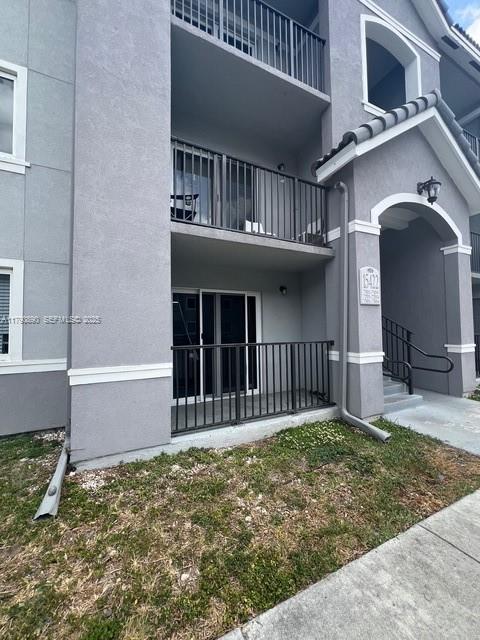 15422 Southwest 284th Street, Unit 7104 Homestead, FL 33033 - Photo 3 of 31 a front view of a house with a yard