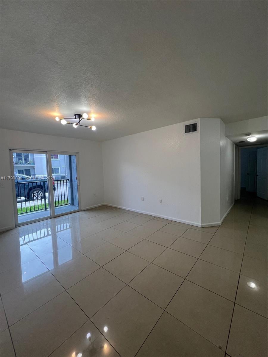 15422 Southwest 284th Street, Unit 7104 Homestead, FL 33033 - Photo 4 of 31 a view of an empty room