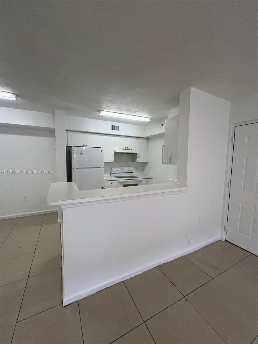 15422 Southwest 284th Street, Unit 7104 Homestead, FL 33033 - Photo 7 of 31 a room with a cabinets and appliances