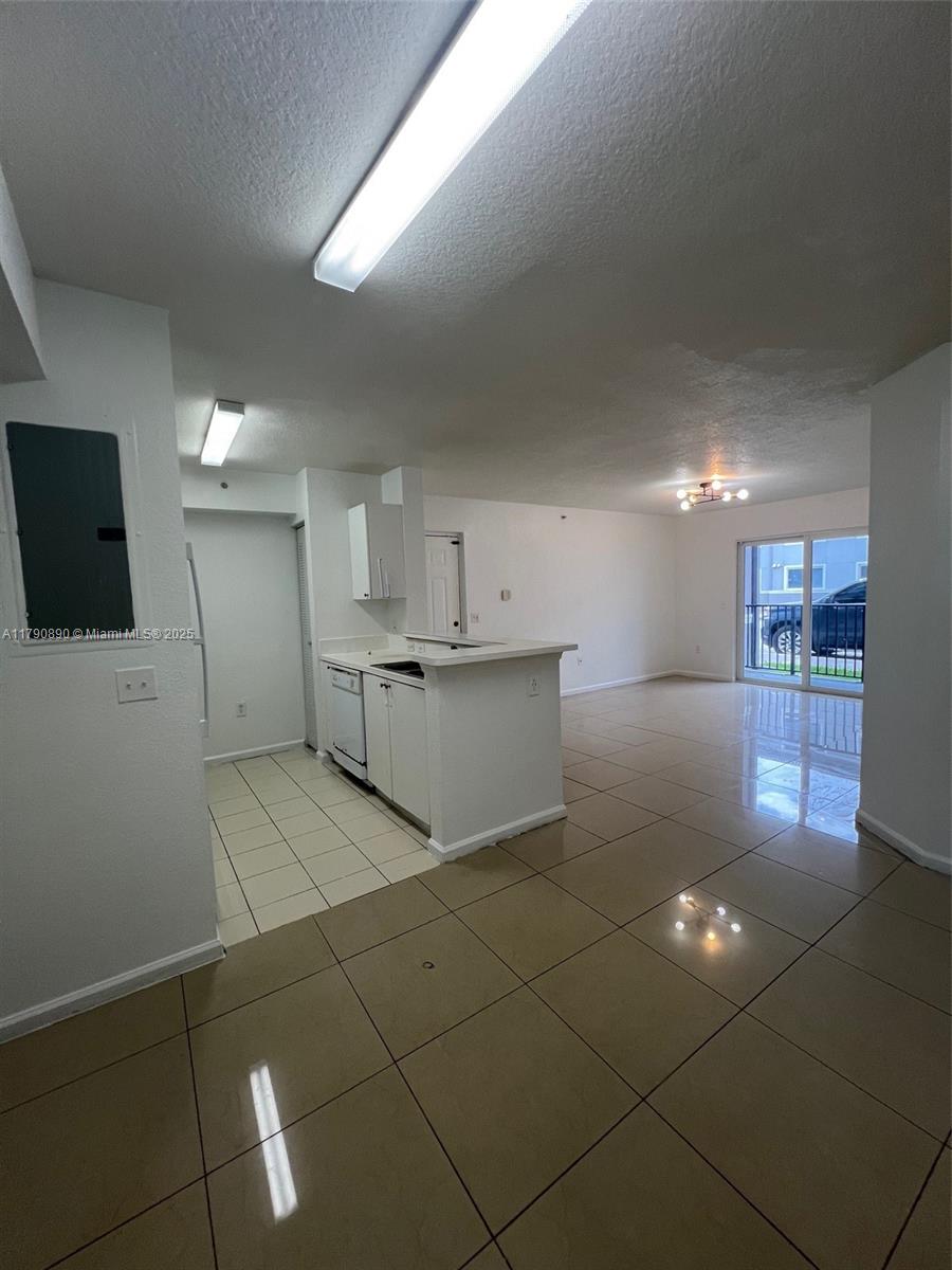 15422 Southwest 284th Street, Unit 7104 Homestead, FL 33033 - Photo 8 of 31 a room with kitchen island stainless steel appliances a sink and cabinets