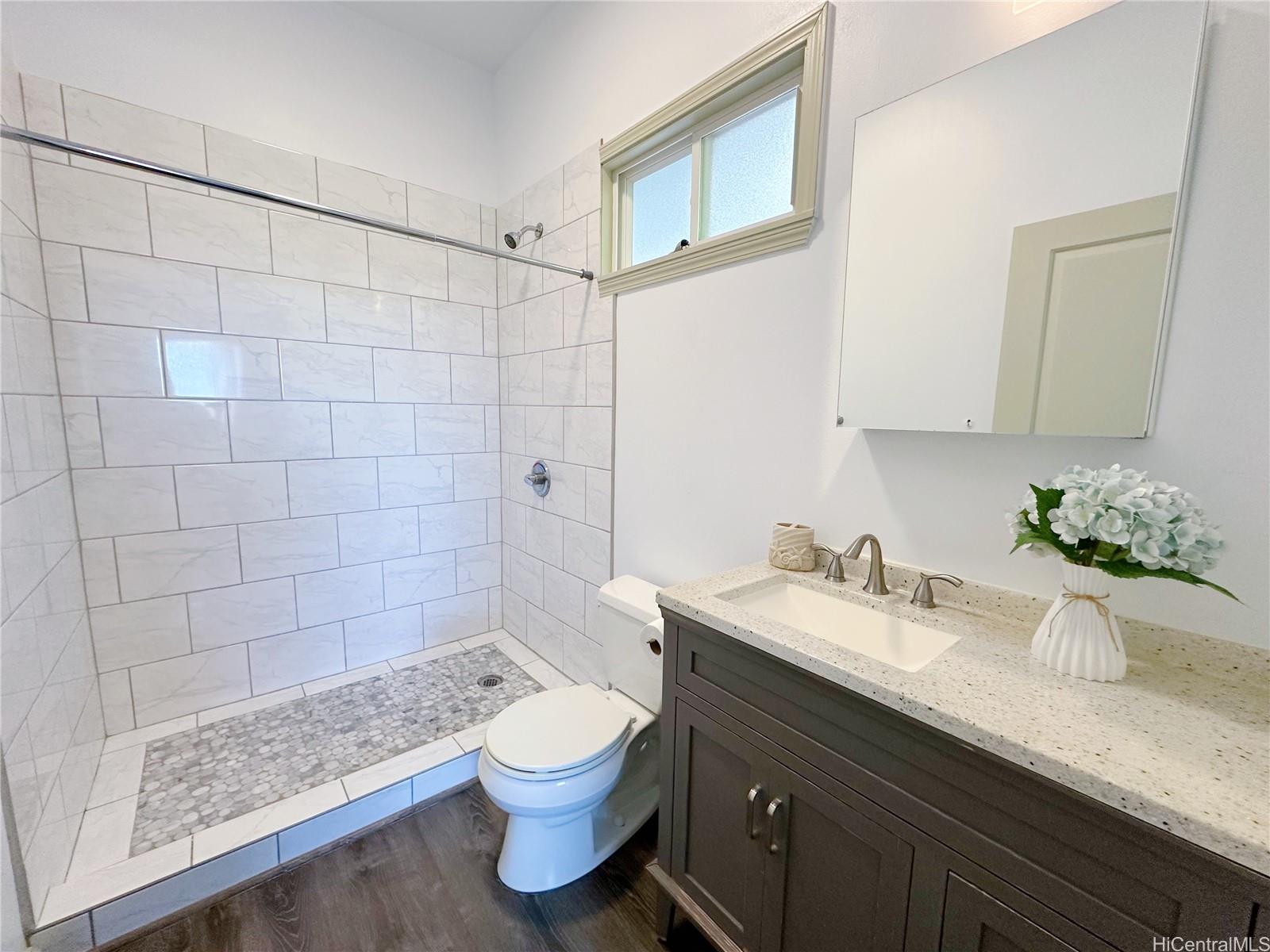 2578 Pacific Heights Road Honolulu, HI 96813 - Photo 16 of 25 a bathroom with a granite countertop sink a toilet and shower