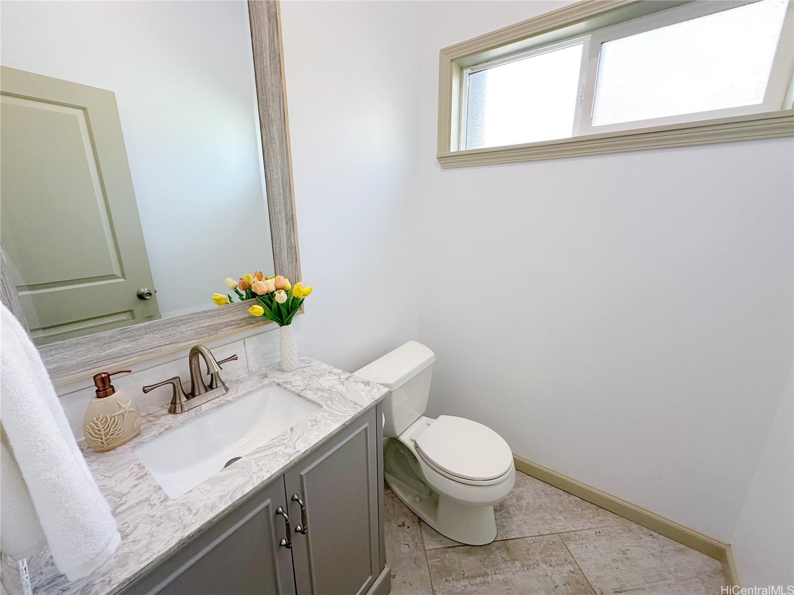 2578 Pacific Heights Road Honolulu, HI 96813 - Photo 20 of 25 a bathroom with a granite countertop sink and a mirror