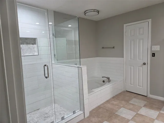 a bathroom with a bathtub and a shower
