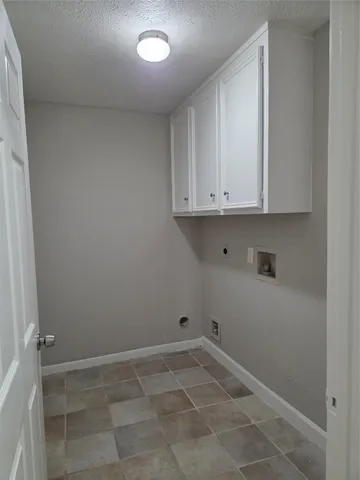 a view of kitchen with white cabinets