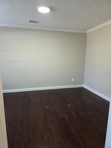 a view of a room with wooden floor