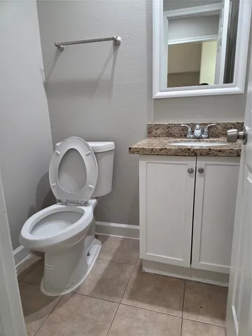 a bathroom with a toilet and a mirror