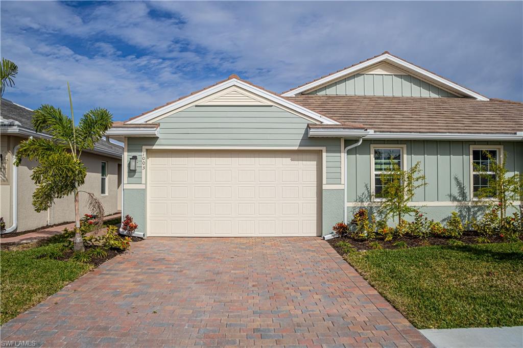 1003 Enbrook Loop Naples, FL 34114 - Photo 1 of 20 a front view of a house with garden