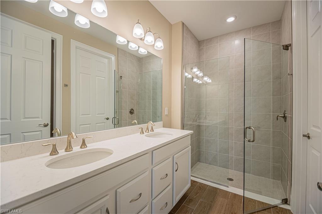 1003 Enbrook Loop Naples, FL 34114 - Photo 6 of 20 a bathroom with a sink double vanity and a mirror