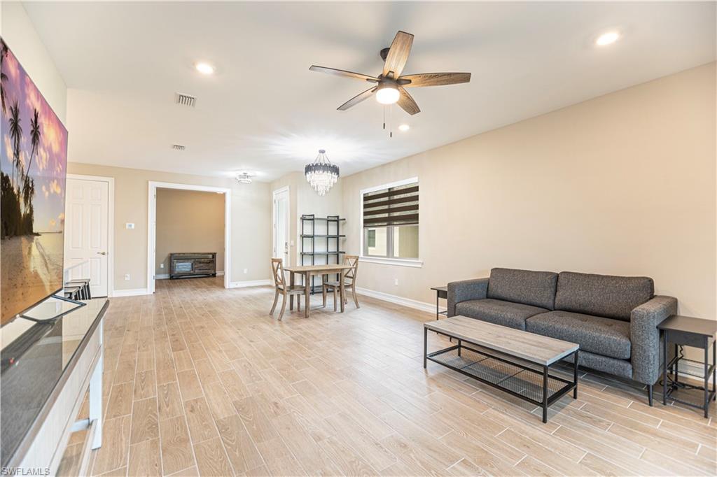 1003 Enbrook Loop Naples, FL 34114 - Photo 7 of 20 a living room with furniture and a flat screen tv