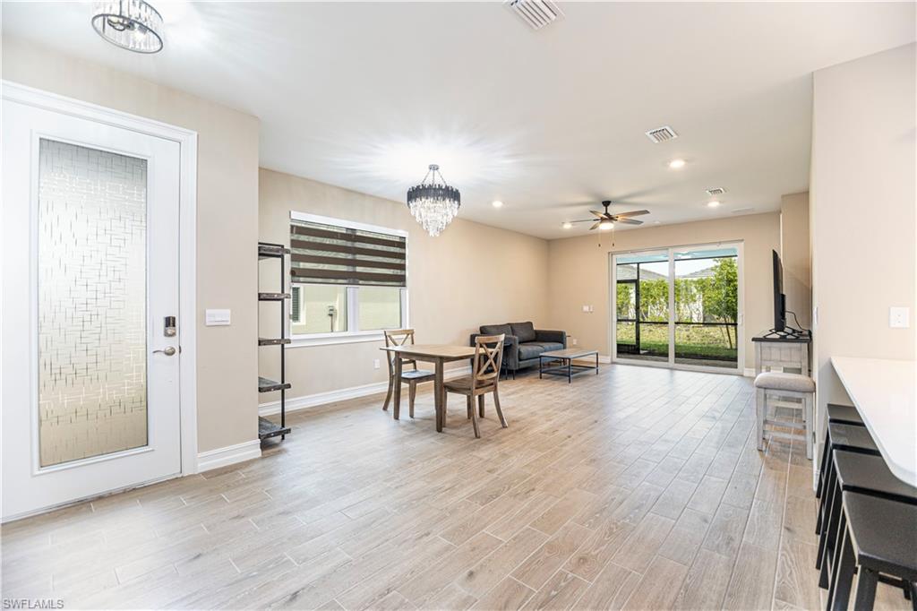 1003 Enbrook Loop Naples, FL 34114 - Photo 9 of 20 a view of a livingroom with furniture window and wooden floor