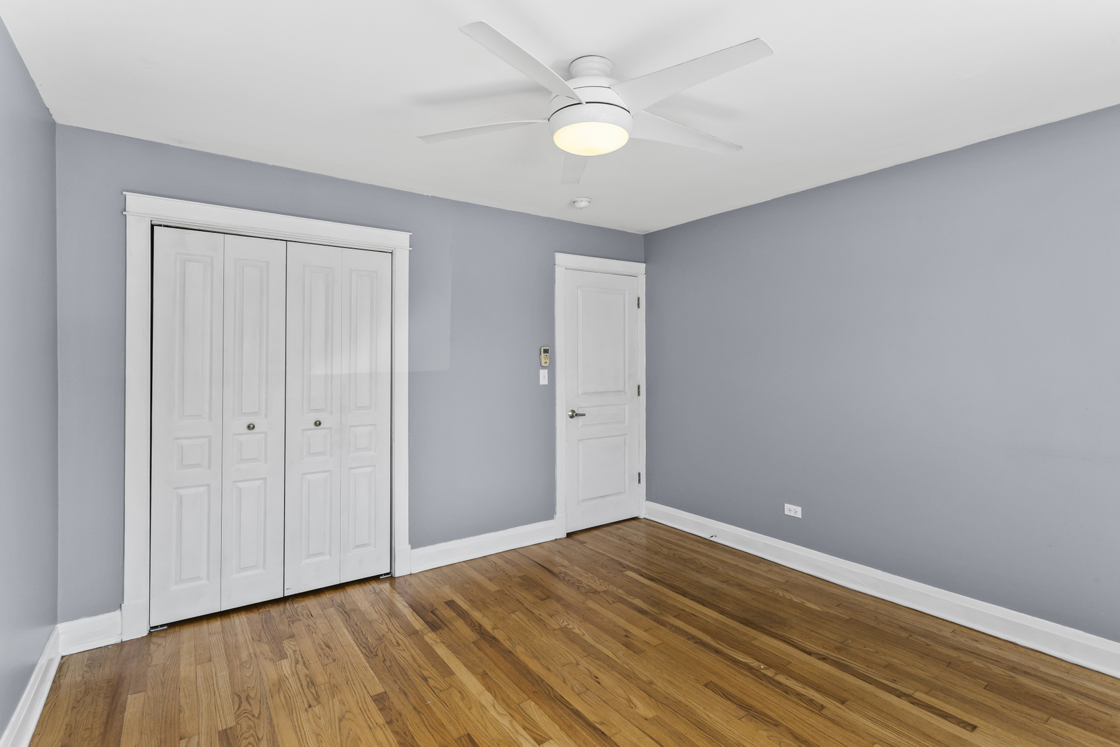 6060 North Ridge Avenue, Unit 2H Chicago, IL 60660 - Photo 12 of 23 a view of an empty room with wooden floor