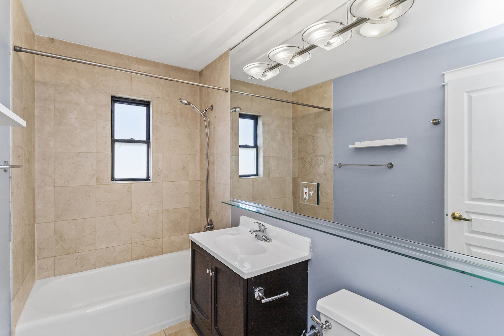 6060 North Ridge Avenue, Unit 2H Chicago, IL 60660 - Photo 13 of 23 a bathroom with a sink a toilet and shower
