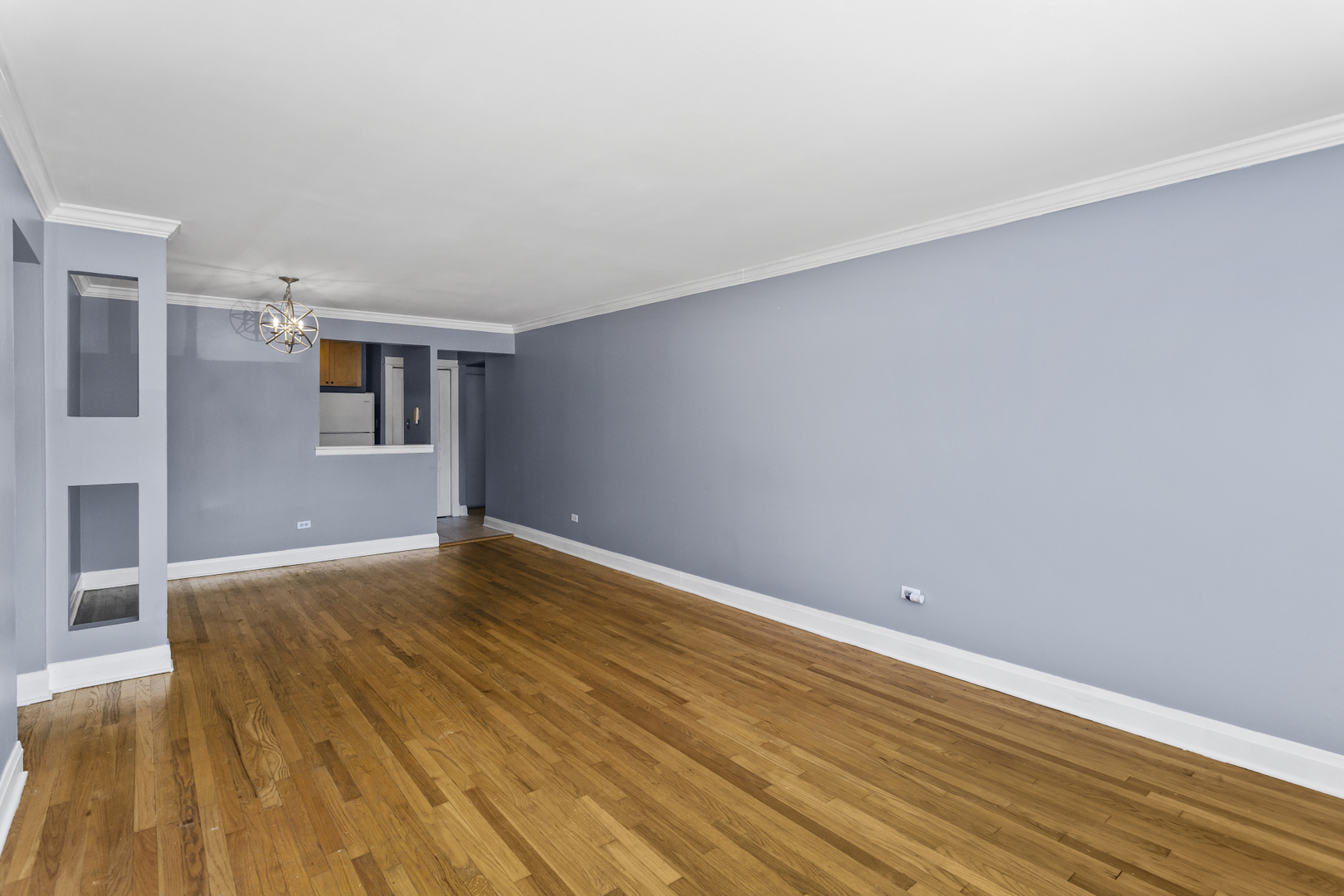 6060 North Ridge Avenue, Unit 2H Chicago, IL 60660 - Photo 4 of 23 a view of empty room with wooden floor and fan