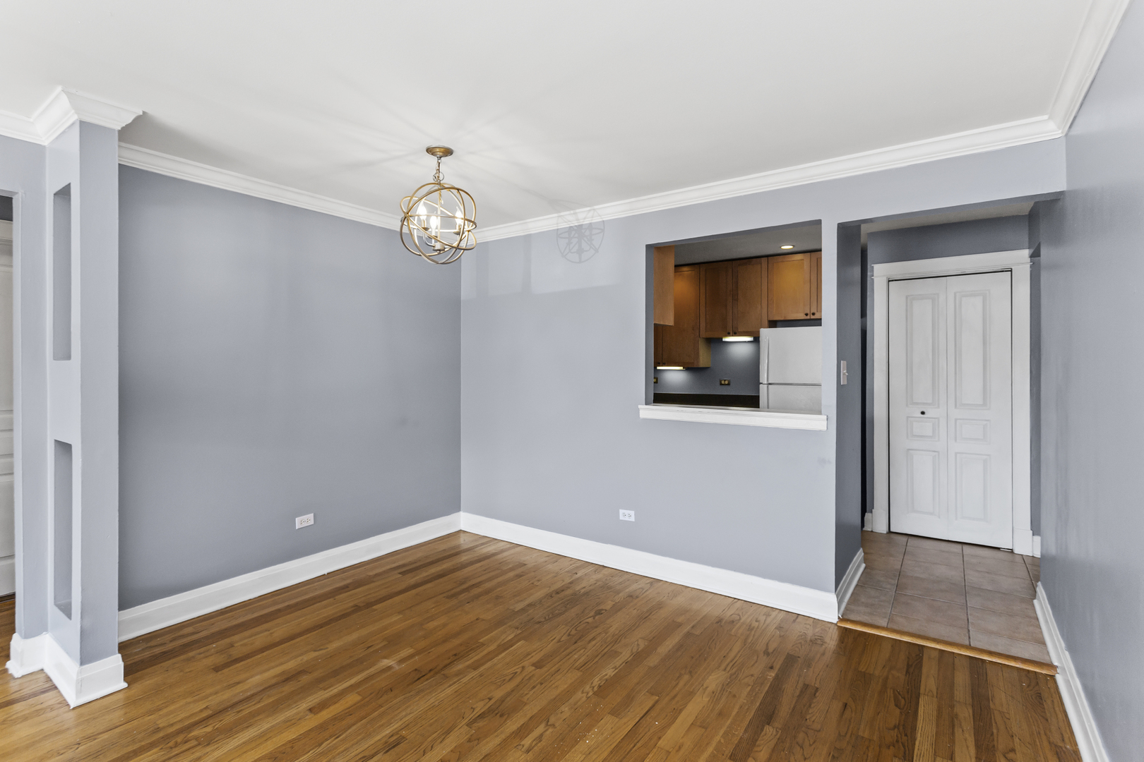 6060 North Ridge Avenue, Unit 2H Chicago, IL 60660 - Photo 6 of 23 a view of empty room with wooden floor and fan