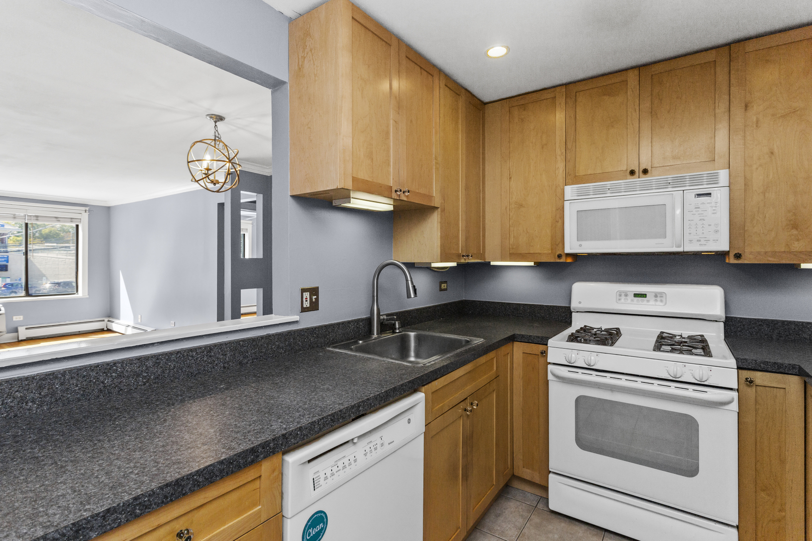 6060 North Ridge Avenue, Unit 2H Chicago, IL 60660 - Photo 7 of 23 a kitchen with stainless steel appliances granite countertop a sink a stove and cabinets