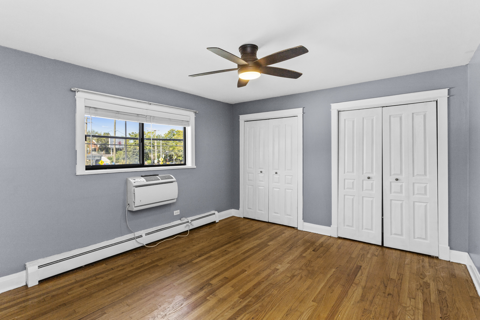 6060 North Ridge Avenue, Unit 2H Chicago, IL 60660 - Photo 9 of 23 a view of empty room with wooden floor and fan