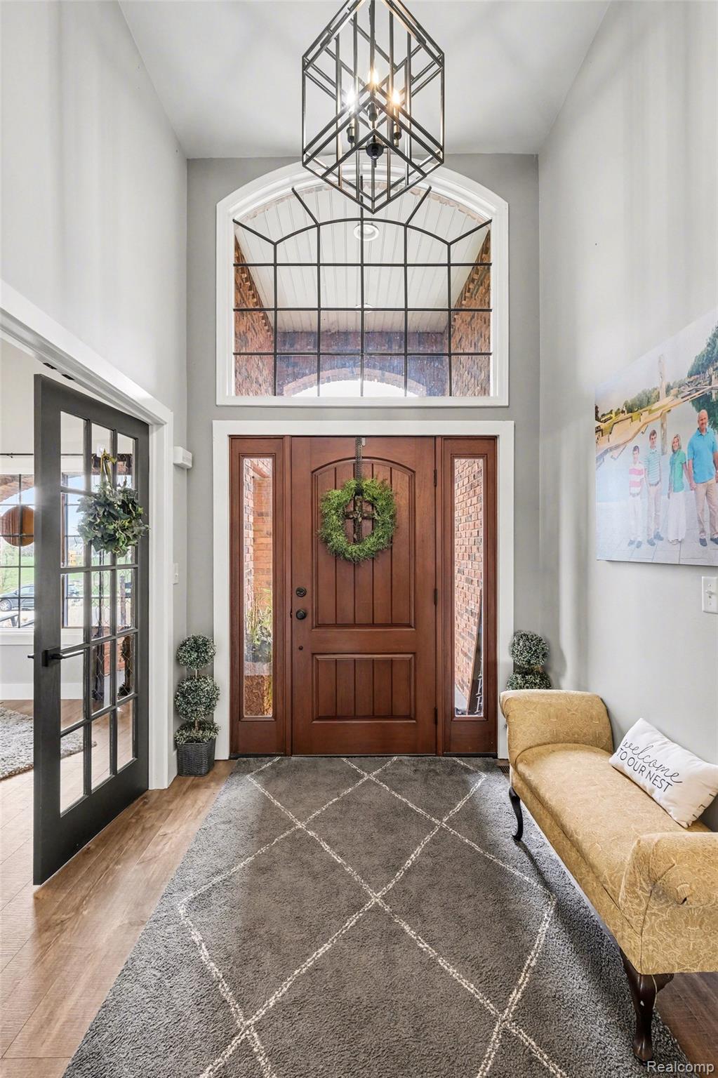 9084 Copper Ridge Drive Davison, MI 48423 - Photo 8 of 42 Foyer with a high ceiling, wood finished floors, french doors, and a chandelier