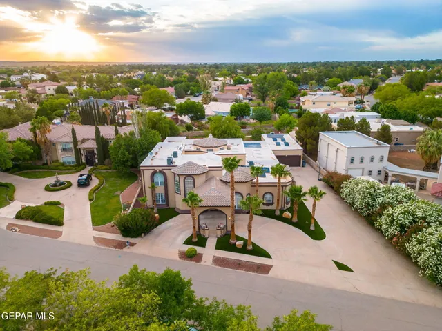 an aerial view of residential houses with outdoor space and street view