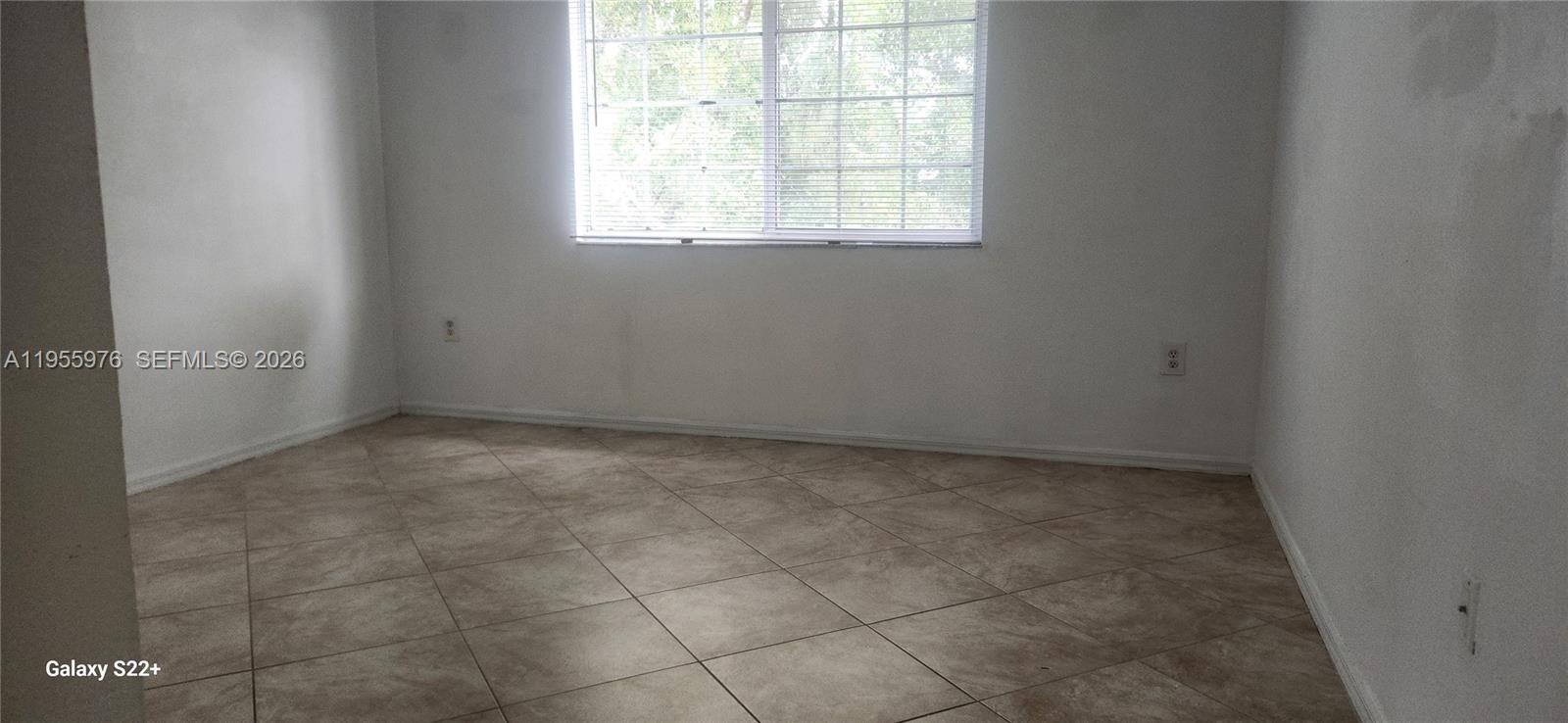 5011 Wiles Road, Unit 306 Coconut Creek, FL 33073 - Photo 17 of 17 an empty room with a empty space and windows