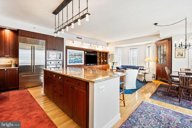 a large kitchen with stainless steel appliances granite countertop a stove and a sink
