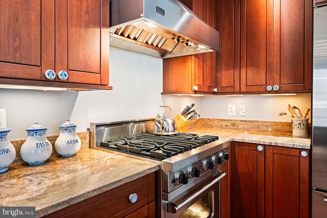 a kitchen with granite countertop stainless steel appliances and counter space