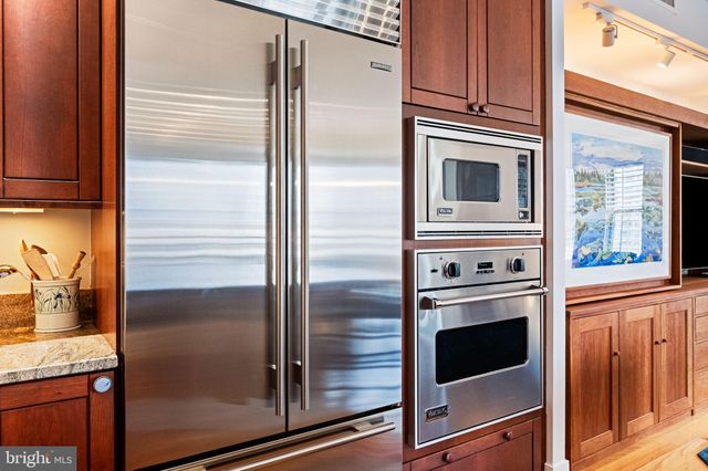 a living room with furniture and a kitchen
