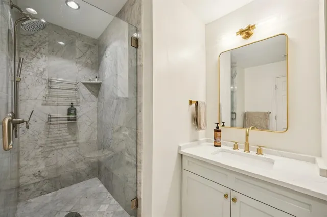 a bathroom with a shower sink and mirror