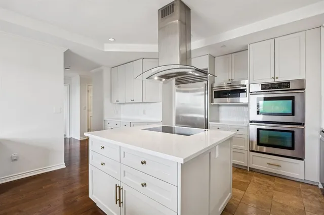 a kitchen that has a sink and a stove in it