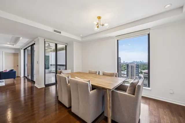 a living room with stainless steel appliances kitchen island granite countertop a stove and a sink