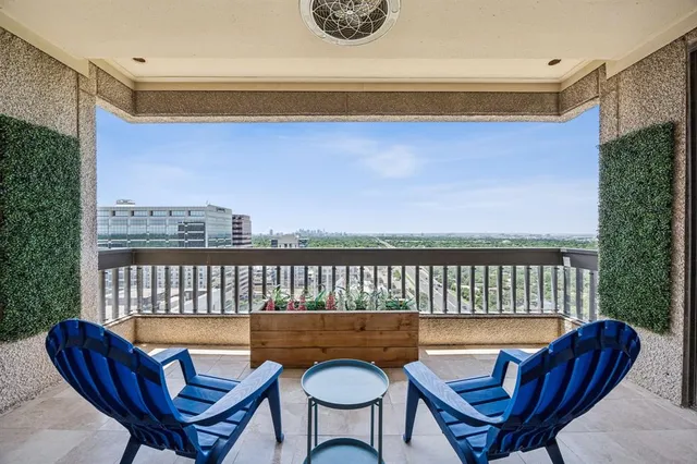 a balcony with table and chairs