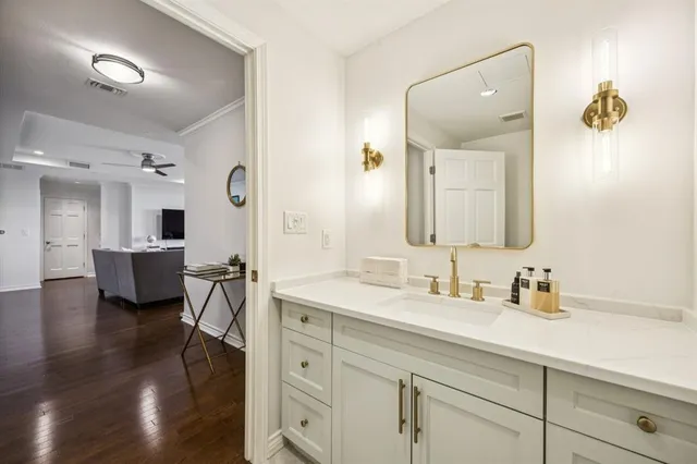 a en suite bathroom with double vanity a sink and mirrors