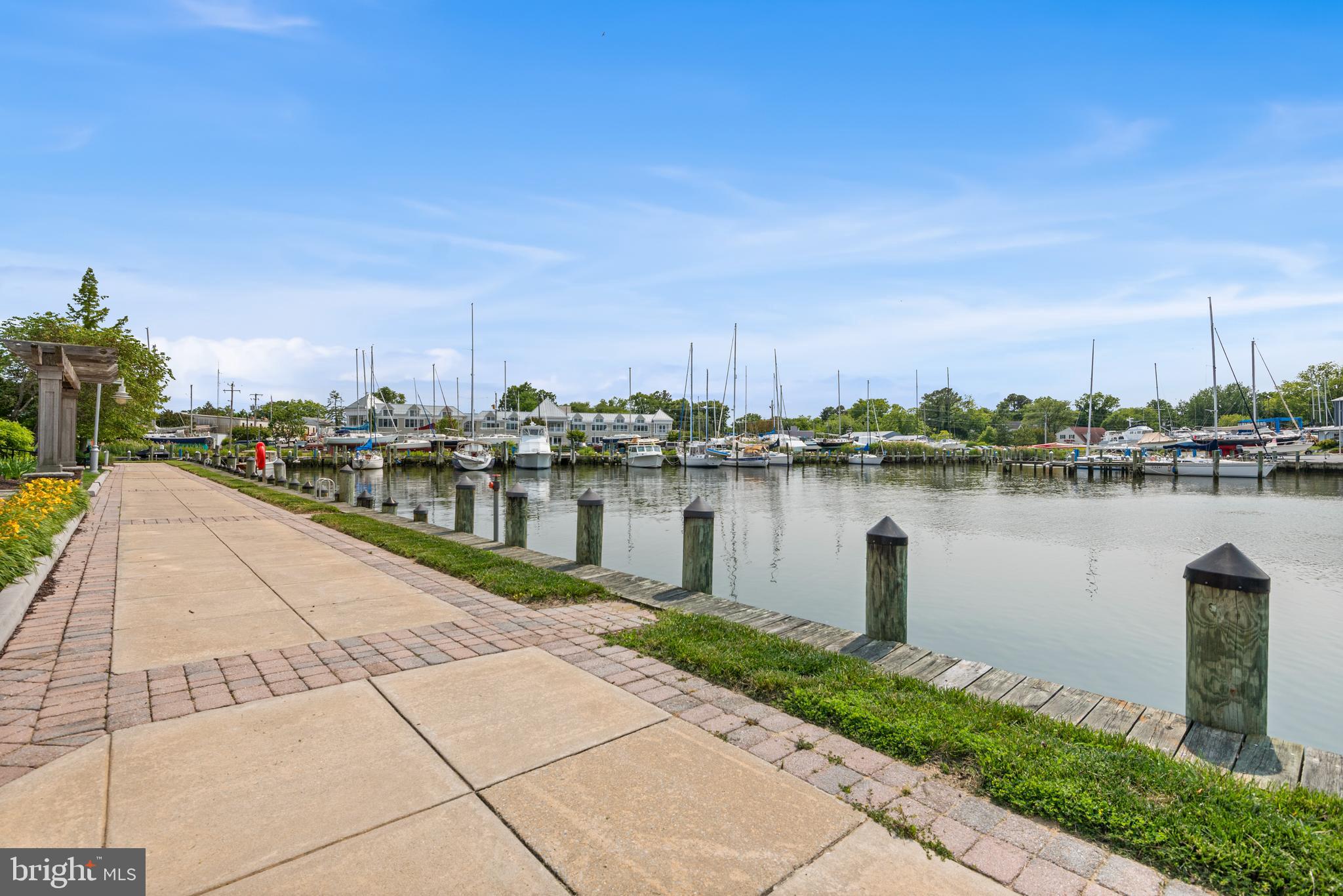 900 Marshy Cove, Unit 103 Cambridge, MD 21613 - Photo 16 of 19 a view of a lake with a yard and a large building