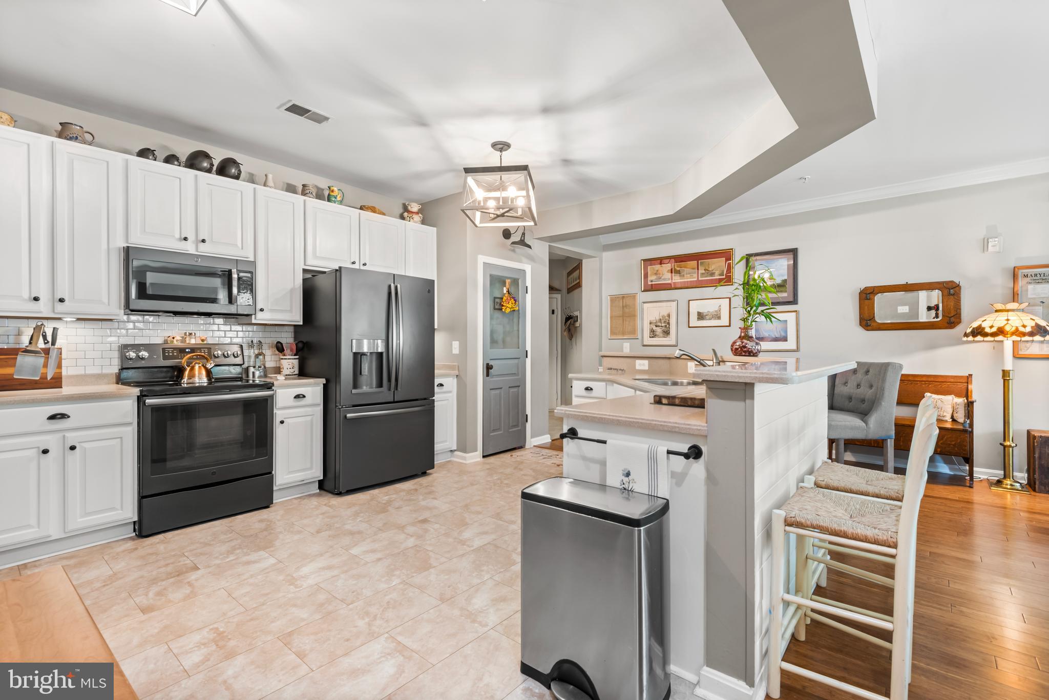 900 Marshy Cove, Unit 103 Cambridge, MD 21613 - Photo 3 of 19 a kitchen with stainless steel appliances a refrigerator stove microwave and sink