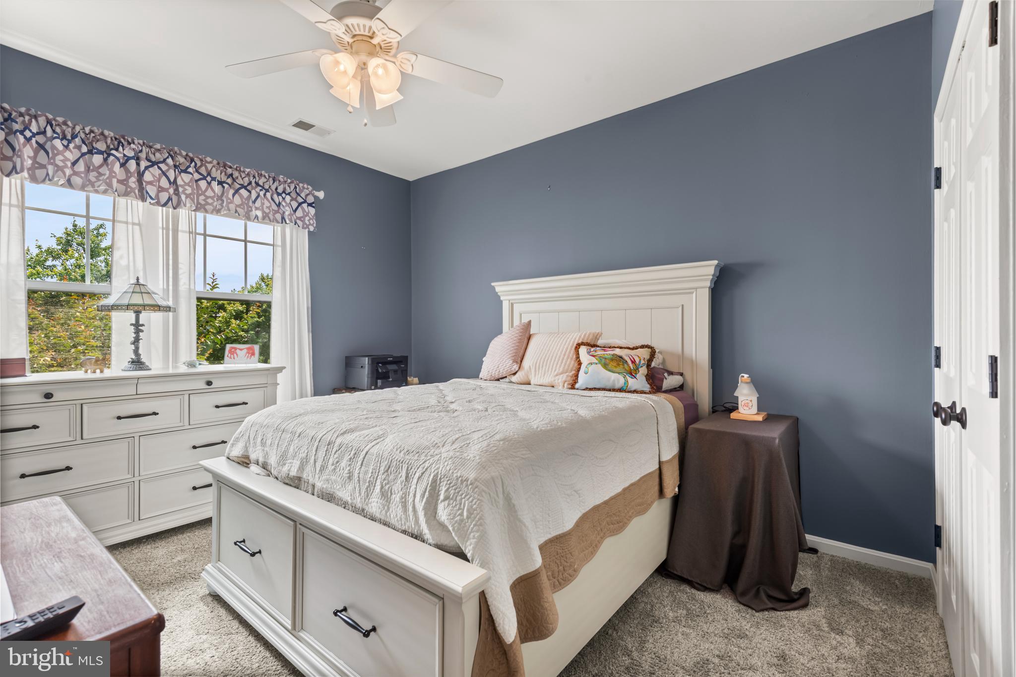 900 Marshy Cove, Unit 103 Cambridge, MD 21613 - Photo 7 of 19 a bedroom with a bed and a window