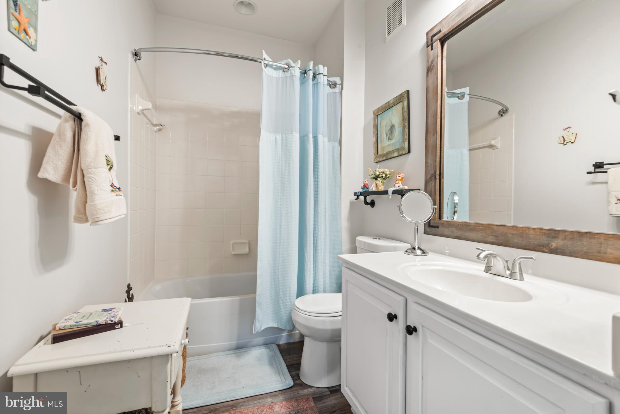 900 Marshy Cove, Unit 103 Cambridge, MD 21613 - Photo 10 of 19 a bathroom with a sink a toilet and shower