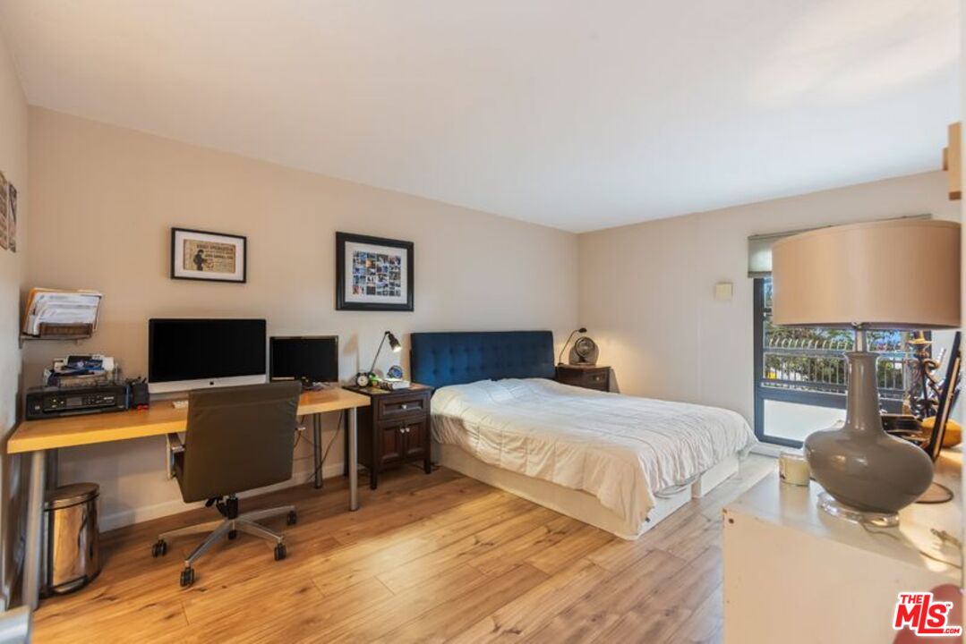 7765 West 91st Street, Unit A2117 Playa del Rey, CA 90293 - Photo 14 of 27 a bedroom with a workspace and a couch