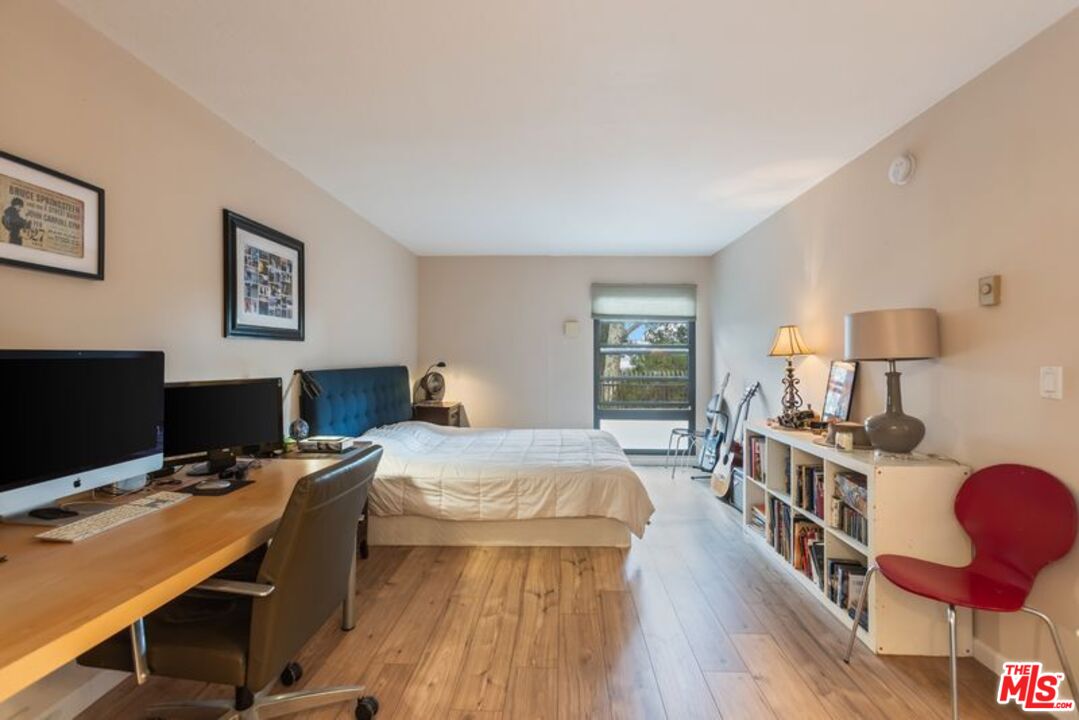 7765 West 91st Street, Unit A2117 Playa del Rey, CA 90293 - Photo 15 of 27 a bedroom with furniture and a wooden floor