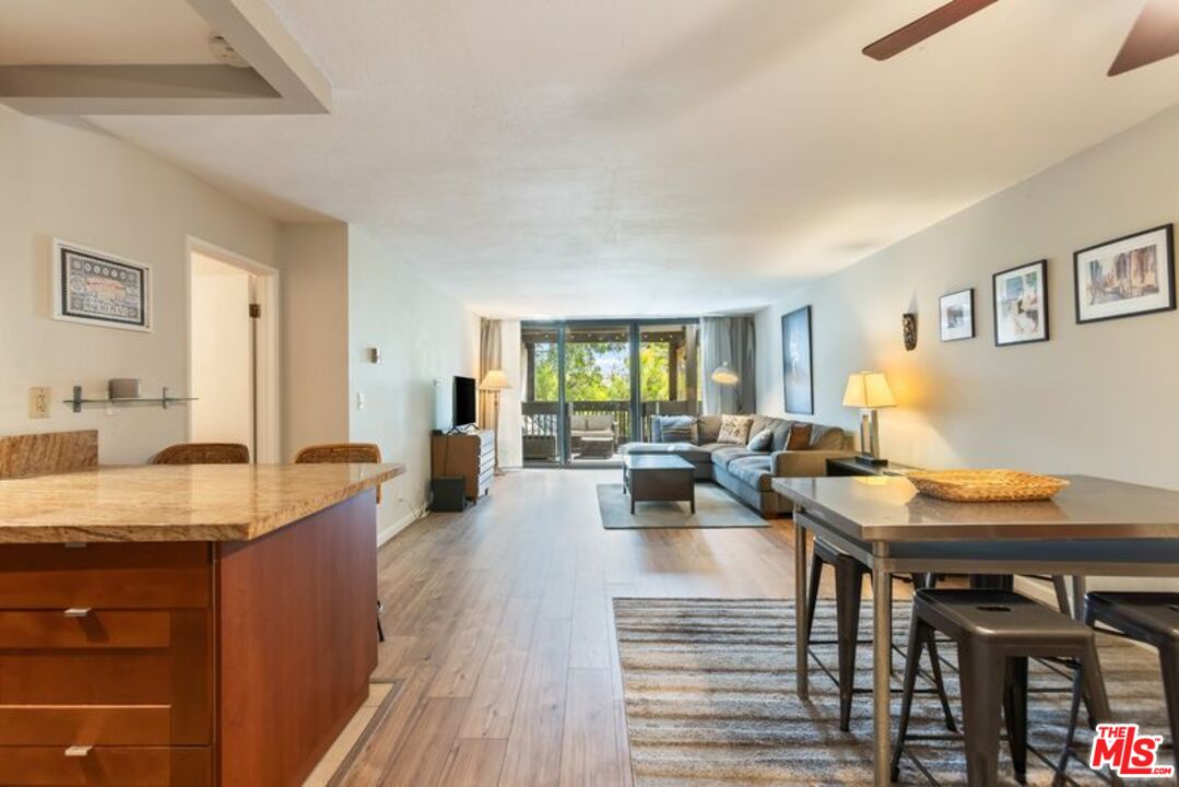 7765 West 91st Street, Unit A2117 Playa del Rey, CA 90293 - Photo 2 of 27 a living room with granite countertop furniture and a wooden table