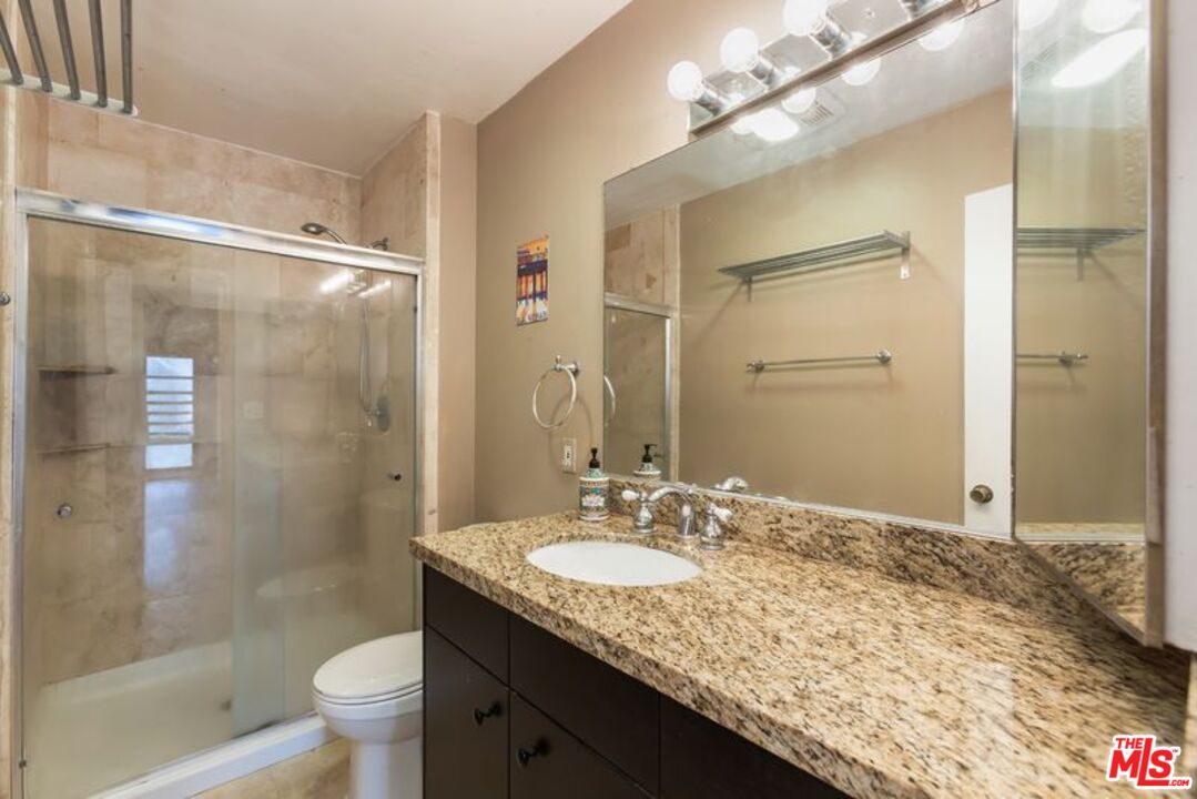 7765 West 91st Street, Unit A2117 Playa del Rey, CA 90293 - Photo 22 of 27 a bathroom with a granite countertop sink toilet and shower