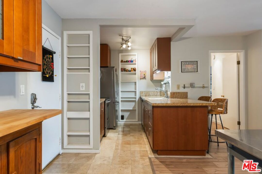 7765 West 91st Street, Unit A2117 Playa del Rey, CA 90293 - Photo 6 of 27 a kitchen with stainless steel appliances granite countertop a sink stove and refrigerator