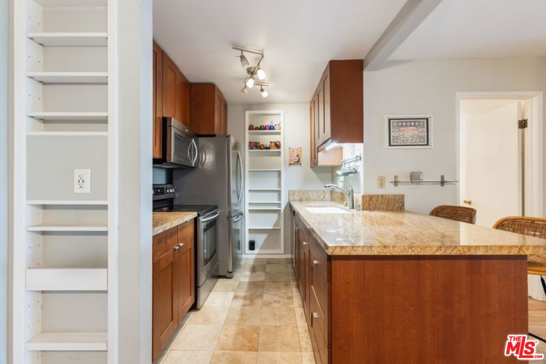 7765 West 91st Street, Unit A2117 Playa del Rey, CA 90293 - Photo 8 of 27 a kitchen with stainless steel appliances granite countertop a refrigerator and a sink