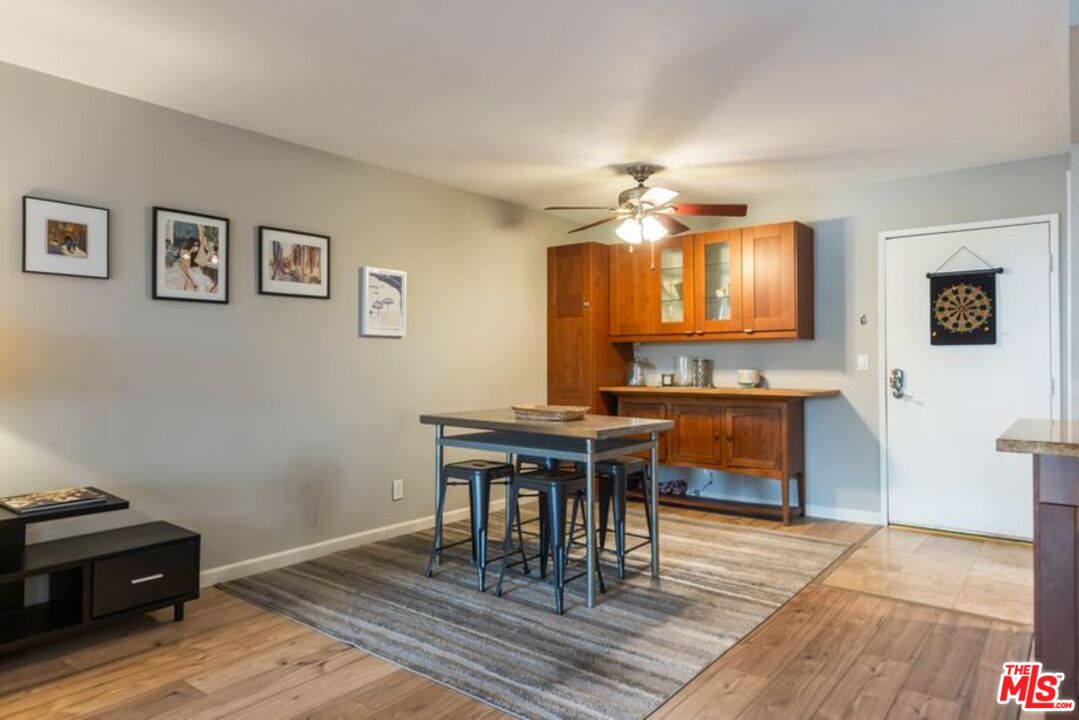 7765 West 91st Street, Unit A2117 Playa del Rey, CA 90293 - Photo 10 of 27 a view of a dining room with furniture and wooden floor