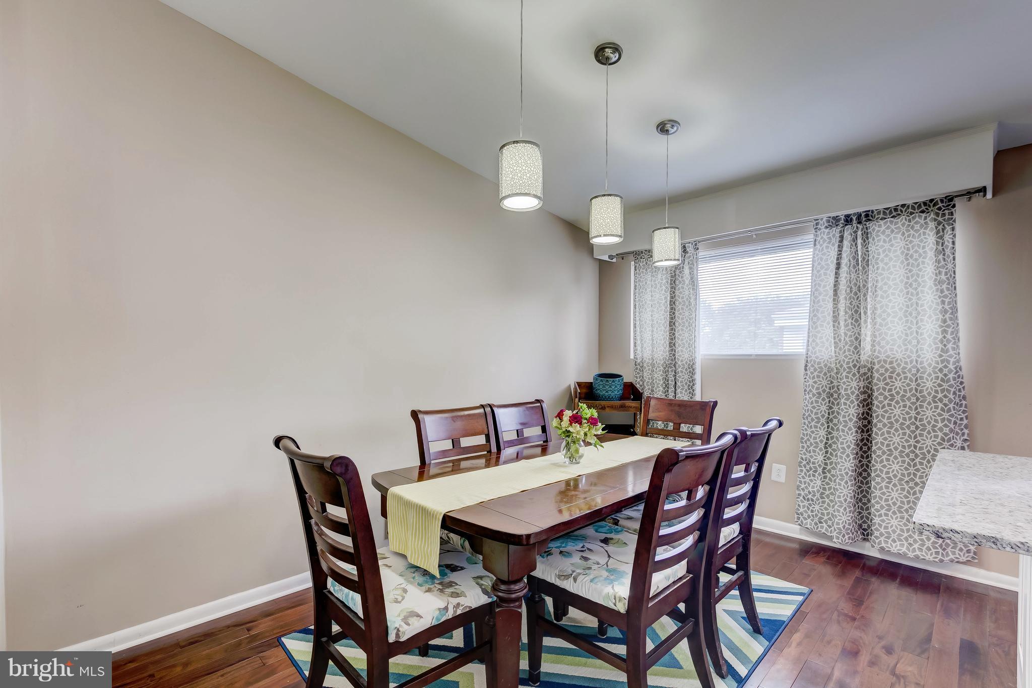 8004 Arrowhead Road Baltimore, MD 21208 - Photo 14 of 30 a view of a dining room with furniture window and wooden floor