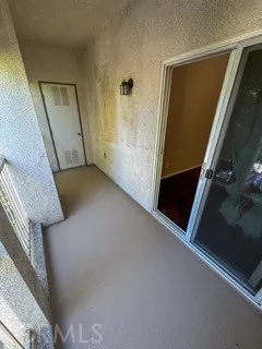 a view of a closet with wooden floor
