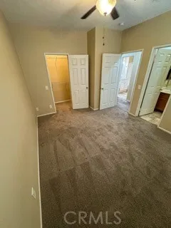 an empty room with a ceiling fan and a window