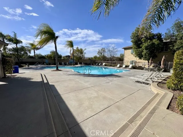 a view of a swimming pool with outdoor seating